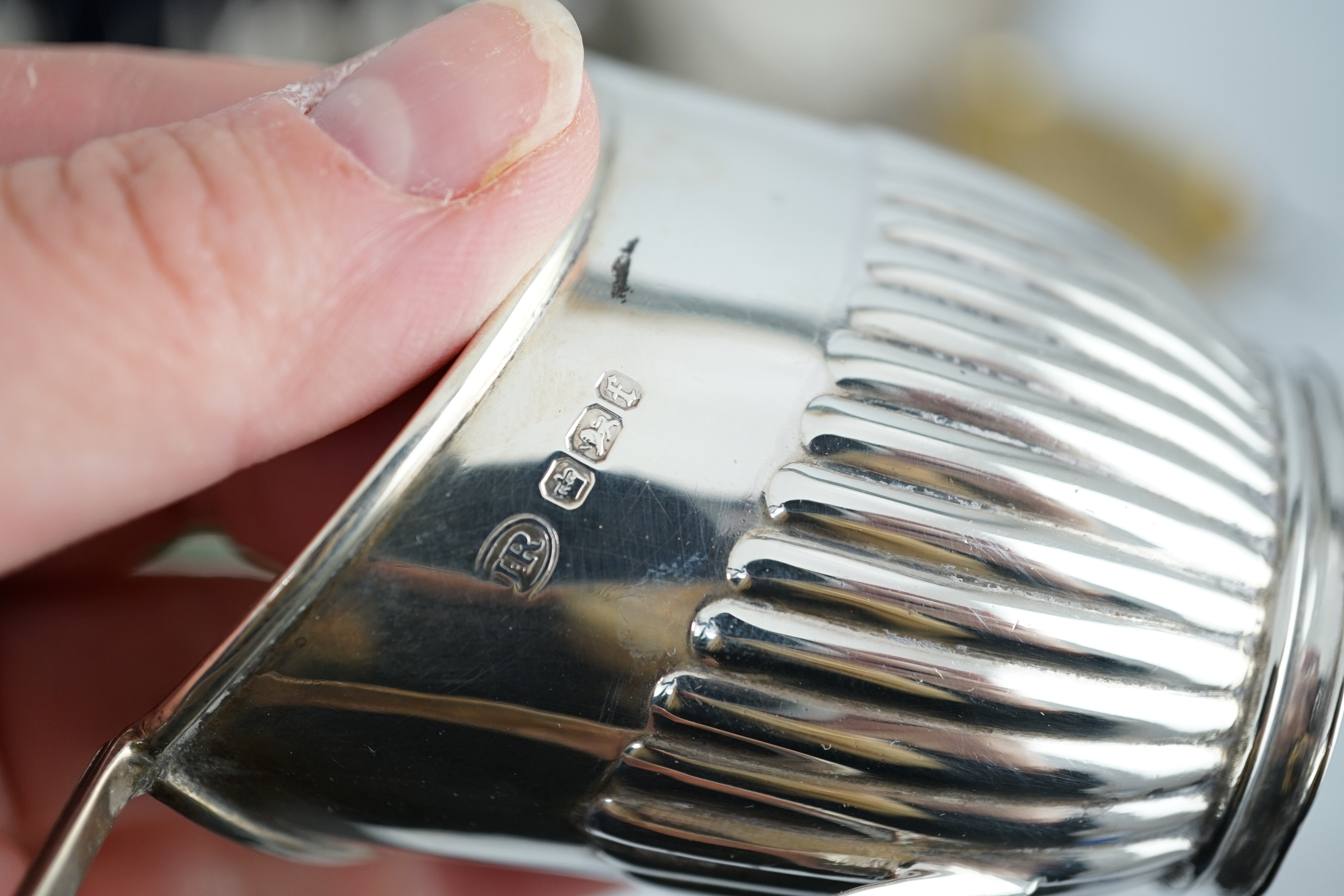 A cased set of twelve George V silver teaspoons with sugar tongs, Sheffield, 1912, two silver hand mirrors, a silver sugar bowl and cream jug, a silver ashtray, a George III silver caddy spoon and cased plated tea knives